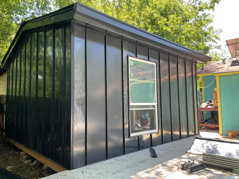 Black standing seam metal wall panels for Roof Inspection in Hutchins